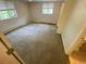 Bright bedroom with neutral carpeting, and natural light from two windows at 7079 Estes Dr, Arvada, CO 80004