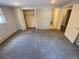 Spacious bedroom with gray carpet, double bi-fold closet, and adjacent bathroom at 7079 Estes Dr, Arvada, CO 80004
