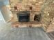 Traditional brick fireplace with decorative screen and mantelpiece in a cozy living space at 7079 Estes Dr, Arvada, CO 80004