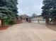 Charming brick home with large driveway and a three-car garage at 7079 Estes Dr, Arvada, CO 80004