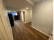 Hallway with modern laminate flooring leading to a kitchen featuring black appliances at 7079 Estes Dr, Arvada, CO 80004