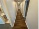 Long hallway with dark hardwood flooring, recessed lighting, and white walls at 7079 Estes Dr, Arvada, CO 80004