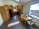 Eat-in kitchen area featuring wood cabinets, black appliances, and a large window for natural light at 7079 Estes Dr, Arvada, CO 80004