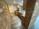 Compact kitchen featuring wood cabinets, black appliances, and unique brick column detail at 7079 Estes Dr, Arvada, CO 80004