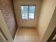Bright landing with tile floor, brick wall, and window for ample natural light at 7079 Estes Dr, Arvada, CO 80004