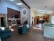 Open concept living space with brick fireplace, skylights, stained glass window, and easy access to the kitchen at 7079 Estes Dr, Arvada, CO 80004