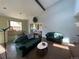 Bright living room with high ceilings, a large window, brick floors, and comfortable seating at 7079 Estes Dr, Arvada, CO 80004
