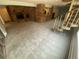 Large, carpeted living room with spiral staircase and a decorative brick fireplace at 7079 Estes Dr, Arvada, CO 80004