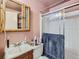 The bathroom features a shower, sliding glass door, and a mirrored medicine cabinet at 1265 Colorado Blvd # 7, Denver, CO 80206