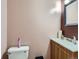 Cozy half-bathroom featuring a mirrored medicine cabinet and classic fixtures at 1265 Colorado Blvd # 7, Denver, CO 80206