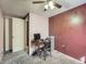 Bedroom featuring a ceiling fan, work desk, and neutral-toned walls with carpet at 1265 Colorado Blvd # 7, Denver, CO 80206