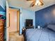 Comfortable bedroom featuring a blue accent wall, a ceiling fan, and a closet at 1265 Colorado Blvd # 7, Denver, CO 80206