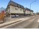 Apartment complex with ample parking and vintage architecture, featuring elevated units and brick facade at 1265 Colorado Blvd # 7, Denver, CO 80206