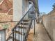 Apartment complex exterior showing stairway access to a unit with stone foundation and elevated entry at 1265 Colorado Blvd # 7, Denver, CO 80206