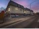 Apartment complex with ample parking and vintage architecture, featuring elevated units and brick facade at 1265 Colorado Blvd # 7, Denver, CO 80206