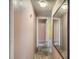 Hallway featuring neutral colored walls and carpet leading to a bathroom and bedroom at 1265 Colorado Blvd # 7, Denver, CO 80206