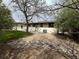 Landscaped backyard shows patio doors, a small lawn, and a large rock feature at 6085 Simms St, Arvada, CO 80004