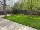 Spacious, green backyard with mature trees and a wood fence offers plenty of shade at 6085 Simms St, Arvada, CO 80004