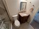 Tiled bathroom features tub with shower, vanity sink, and decorative mirror at 6085 Simms St, Arvada, CO 80004