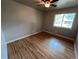 Bedroom featuring hardwood floors, neutral walls, a ceiling fan and bright natural light at 6085 Simms St, Arvada, CO 80004