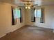 Neutral bedroom features standard ceiling fan, carpet, and natural light from two windows at 6085 Simms St, Arvada, CO 80004