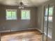 Bright bedroom with hardwood floors, a ceiling fan, and large windows, providing a tranquil retreat at 6085 Simms St, Arvada, CO 80004