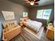 Staged bedroom showcasing a light wood bed frame, hardwood floors and modern decor at 6085 Simms St, Arvada, CO 80004