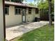 The back of the property features a concrete patio, trimmed windows, and a well-maintained lawn at 6085 Simms St, Arvada, CO 80004