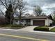 Charming single-story home features a well-maintained front yard and a two-car garage at 6085 Simms St, Arvada, CO 80004