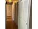 Well-lit hallway with hardwood floors and multiple closet doors for ample storage space at 6085 Simms St, Arvada, CO 80004
