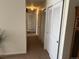 Well-lit hallway features multiple storage closets and neutral paint throughout at 6085 Simms St, Arvada, CO 80004