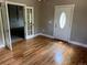 Inviting living room with hardwood floors and white doors, offering a bright and airy atmosphere for gatherings at 6085 Simms St, Arvada, CO 80004