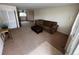 Open living area with neutral carpet leads to a dining area and kitchen at 6085 Simms St, Arvada, CO 80004
