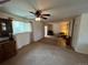 Spacious carpeted living room area with updated ceiling fan and adjacent tile flooring at 6085 Simms St, Arvada, CO 80004