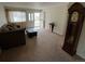 Cozy living room boasts neutral carpeting, a large window and a grandfather clock at 6085 Simms St, Arvada, CO 80004