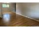 Bright living room boasts gleaming hardwood floors and plenty of natural light, creating a warm ambiance at 6085 Simms St, Arvada, CO 80004