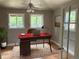 Home office features hardwood floors, lots of windows, and a classic desk, creating a productive workspace at 6085 Simms St, Arvada, CO 80004