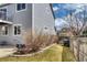 Wide backyard view of the two-story gray home with deck, stairs, and wooden fence at 8459 Sweet Clover Way, Parker, CO 80134