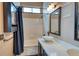 Bright bathroom featuring a bathtub, single sink with a large countertop, and plenty of bathroom storage at 8459 Sweet Clover Way, Parker, CO 80134