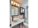 This bathroom features a stylish vessel sink, modern vanity, and a shower-tub combination at 8459 Sweet Clover Way, Parker, CO 80134