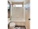 Full bathroom with tiled walls and shower and built-in cabinet at 8459 Sweet Clover Way, Parker, CO 80134