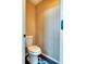 Small half bathroom with a tiled floor, white toilet, and neutral colored walls at 8459 Sweet Clover Way, Parker, CO 80134