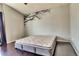 Bedroom with decorative wall tree, dark laminate flooring, and neutral colored walls at 8459 Sweet Clover Way, Parker, CO 80134