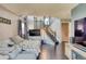 View of the living room with access to a stairwell and decorative fireplace at 8459 Sweet Clover Way, Parker, CO 80134