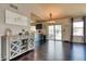 Open-concept living area featuring hardwood floors, neutral decor, and sliding doors to the outdoor deck at 8459 Sweet Clover Way, Parker, CO 80134