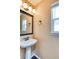 Charming powder room features a pedestal sink and bronze fixtures at 8459 Sweet Clover Way, Parker, CO 80134