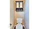 Modern toilet with mounted storage and woven basket at 8459 Sweet Clover Way, Parker, CO 80134