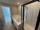 Bathroom featuring a soaking tub and glass enclosed shower with black trim and white subway tile at 18328 E 93Rd Pl, Commerce City, CO 80022