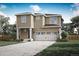 Two-story house with beige siding, two-car garage, and landscaped yard at 18328 E 93Rd Pl, Commerce City, CO 80022