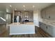 Beautiful kitchen with an island, stainless steel appliances, quartz countertop and gray cabinets at 18328 E 93Rd Pl, Commerce City, CO 80022